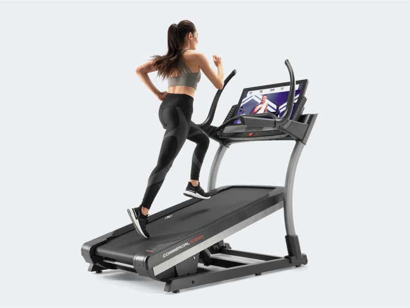 Woman runs on incline treadmill