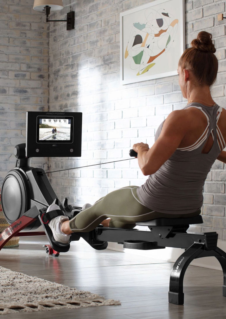 Woman uses rower at home