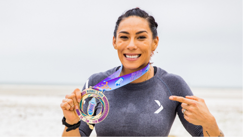 Woman at beach with medal