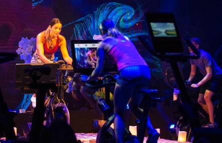 Personal trainer coaches an iFIT cycling class