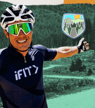 Man with helmet on taking a selfie in wooded landscape