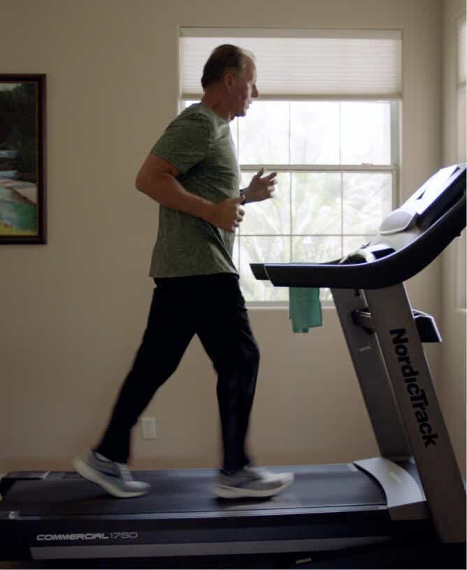 Man running on iFIT treadmill.