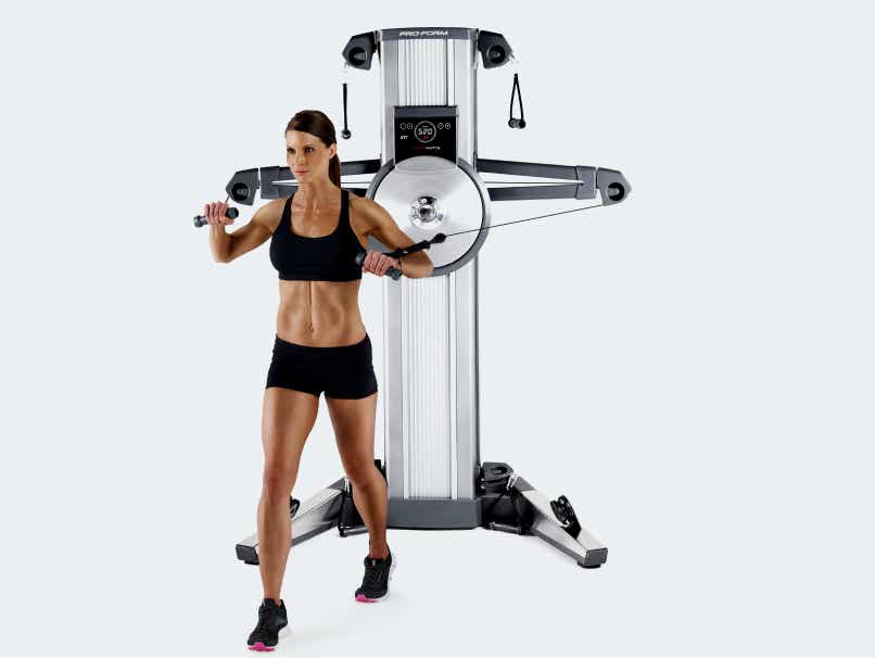 Woman uses cable exercise machine