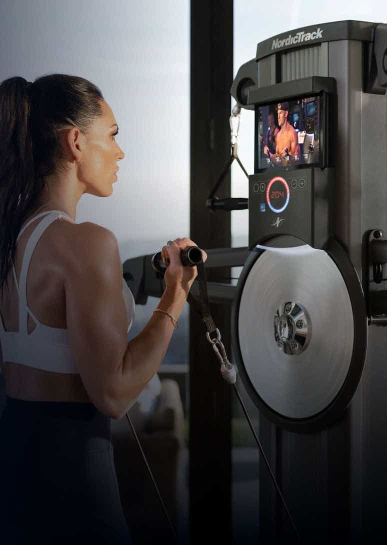 Woman exercising with NordicTrack Fusion Series cable machine