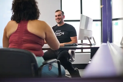 Woman discusses her custom membership plan with an Anytime Fitness staff member