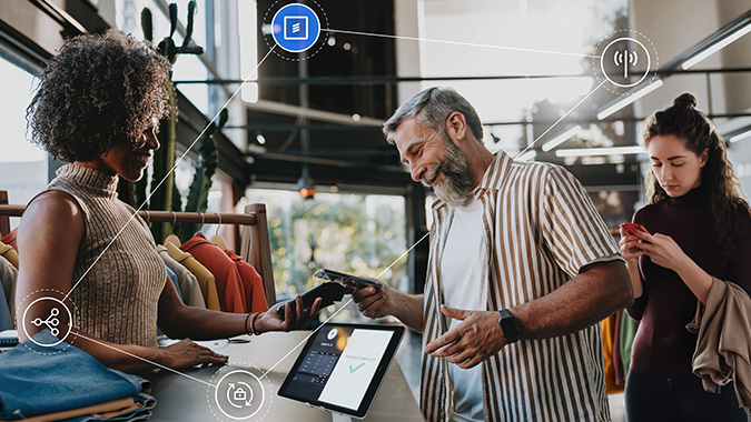 A retail store employee processes a payment on a tablet with Ericsson connectivity feature callouts overlaid on the image.