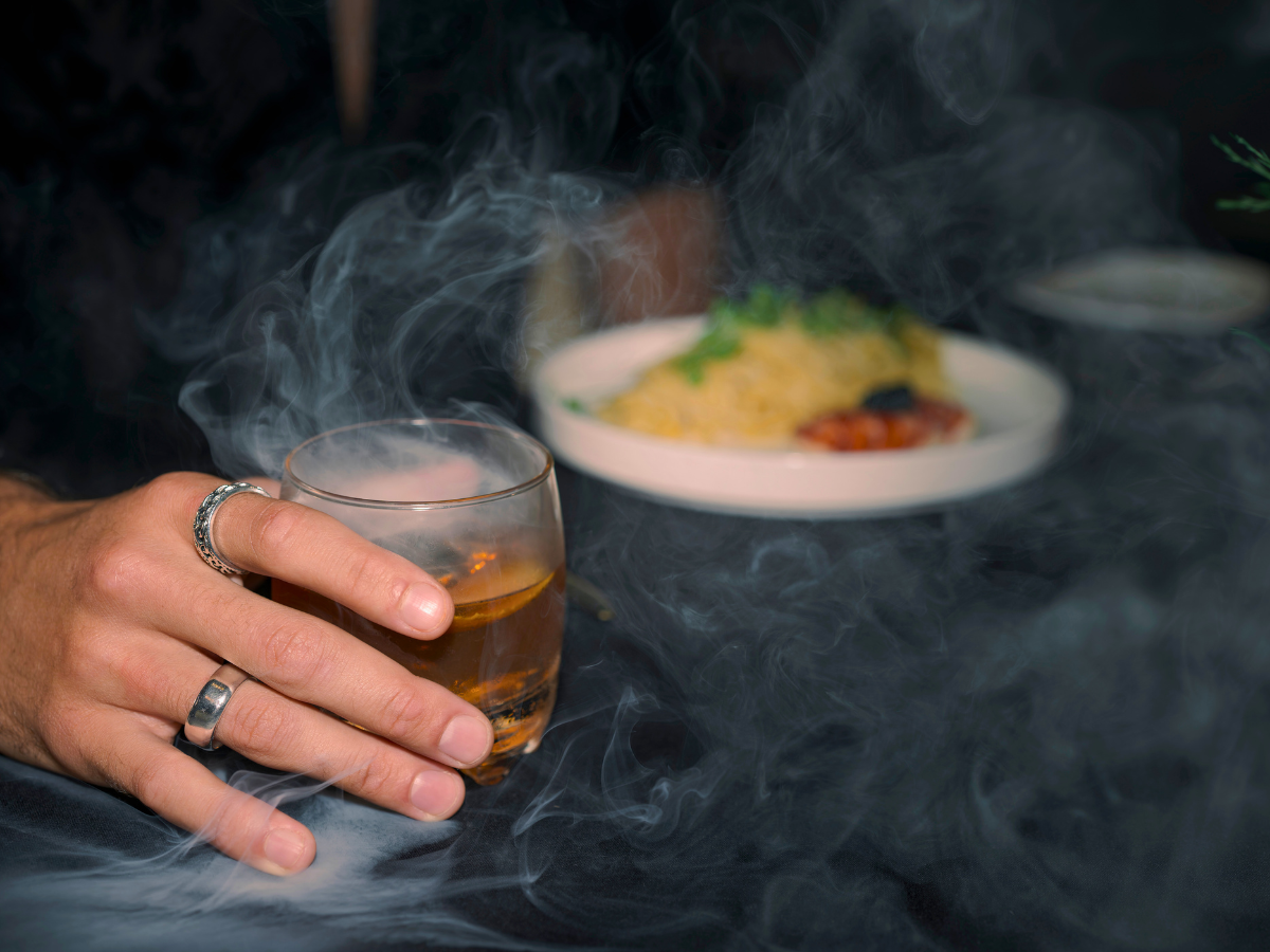 Upscale craft bourbon cocktail with bold, smoky presentation served in a sophisticated glass at Carvers on 19