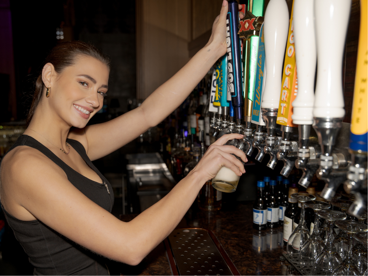 Bartender at Track 5. Pouring Beer