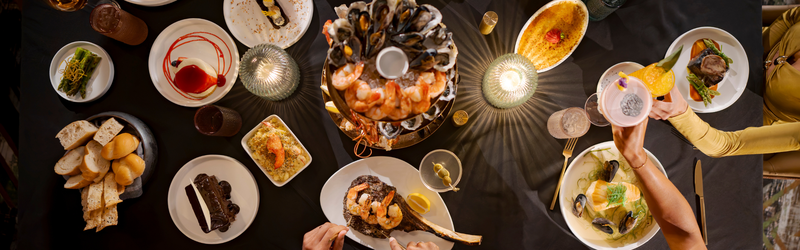 Intimate dining experience with a table full of premium entrees, wine, and bold culinary creations