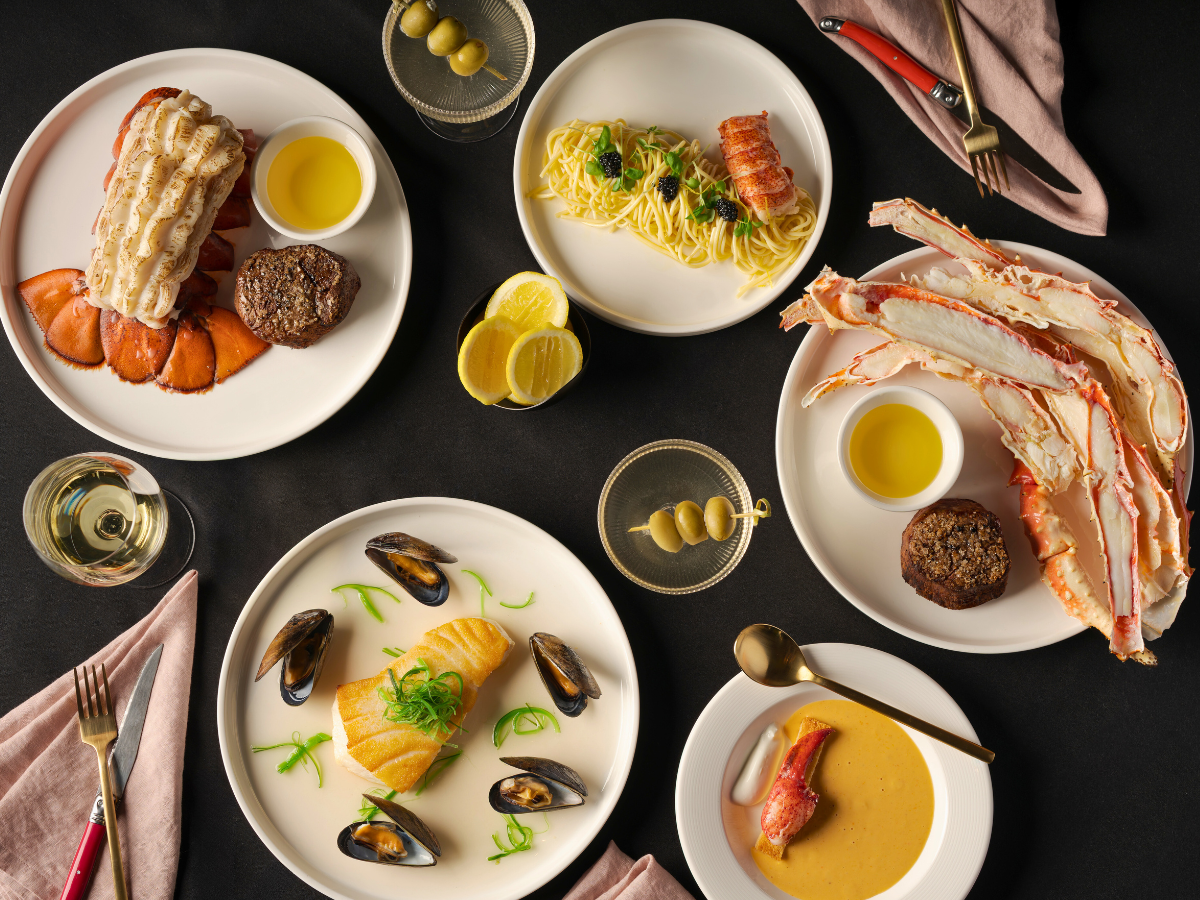 An array of refined seafood dishes paired with chilled martinis, set on a polished table inside Carvers on 19