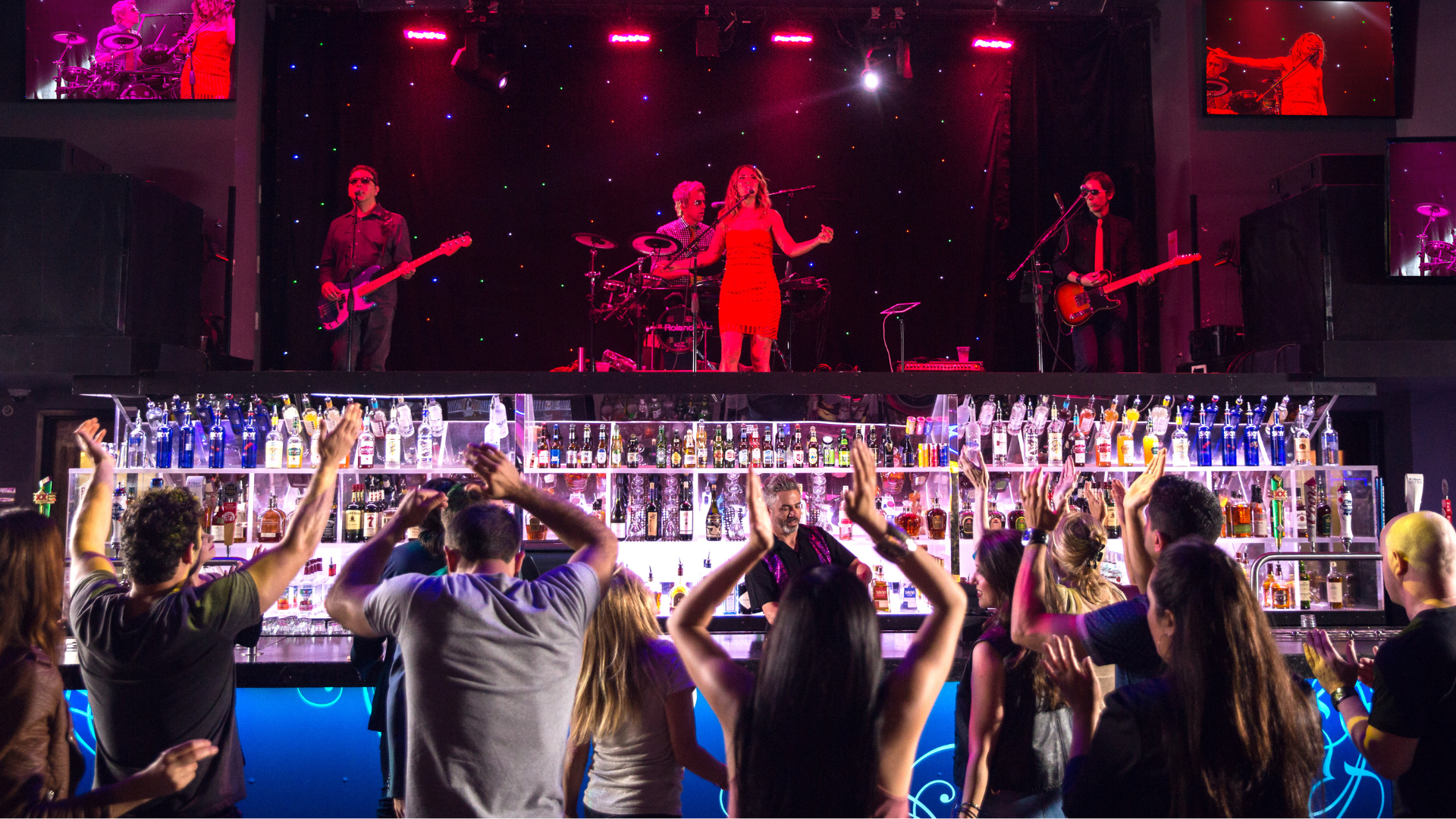 People dancing and watching performer at Riffs Bar
