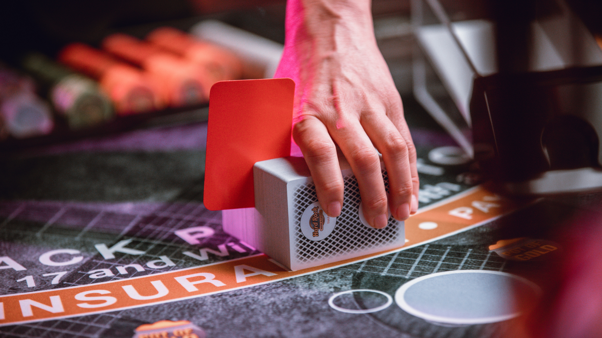 Hand holding cards at poker table
