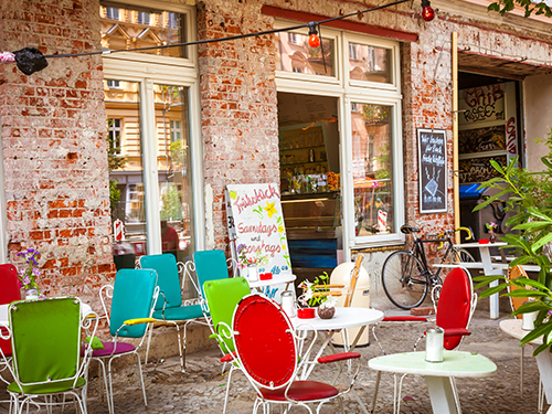 Colourful chairs are placed outside a restuarant cafe in the center of Berlin