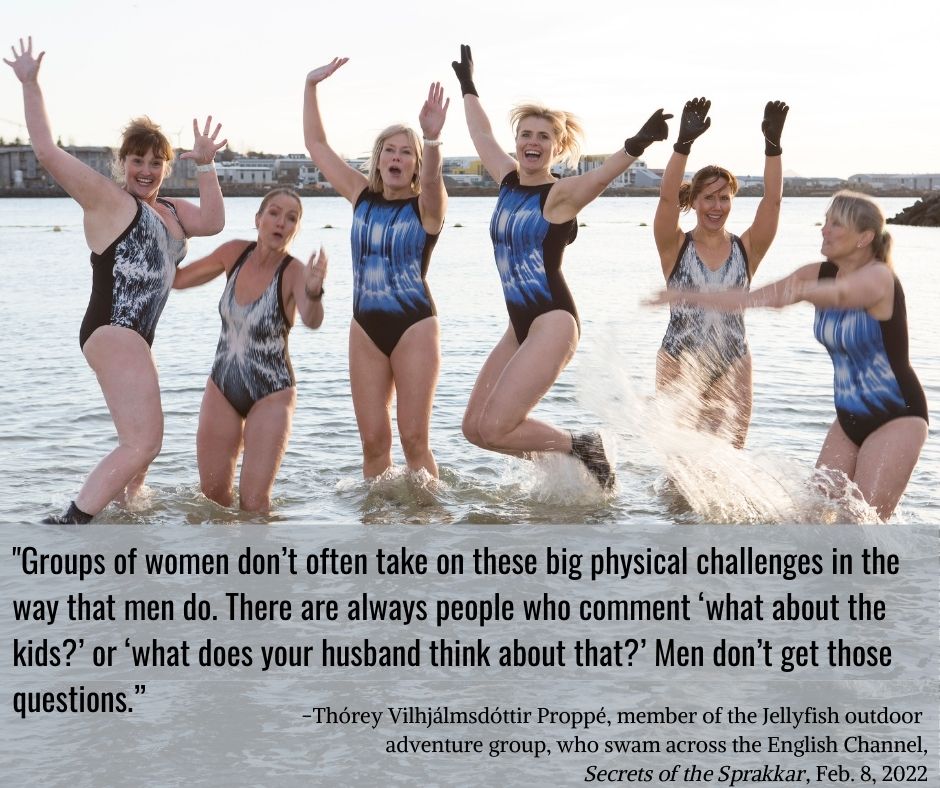 Photo of 6 members of the Jellyfish outdoor adventure group, who swam across the English Channel. The women are in swimsuits, in the shallows of a beach