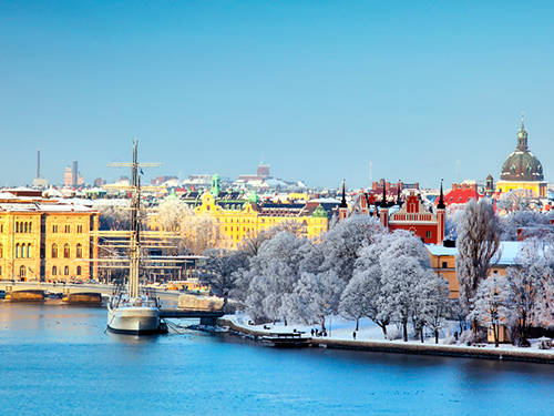 A skyline view of Stockholm, Sweden, as viewed in the wintertime when there is snow on the roofs