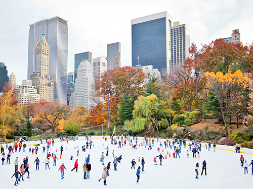 Ice skaters skating on the ice rink at Woolmark Park in the winter season in New York City