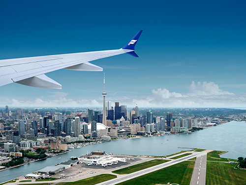 The wing of an Icelandair airplane pictured flying over Toronto, Canada 