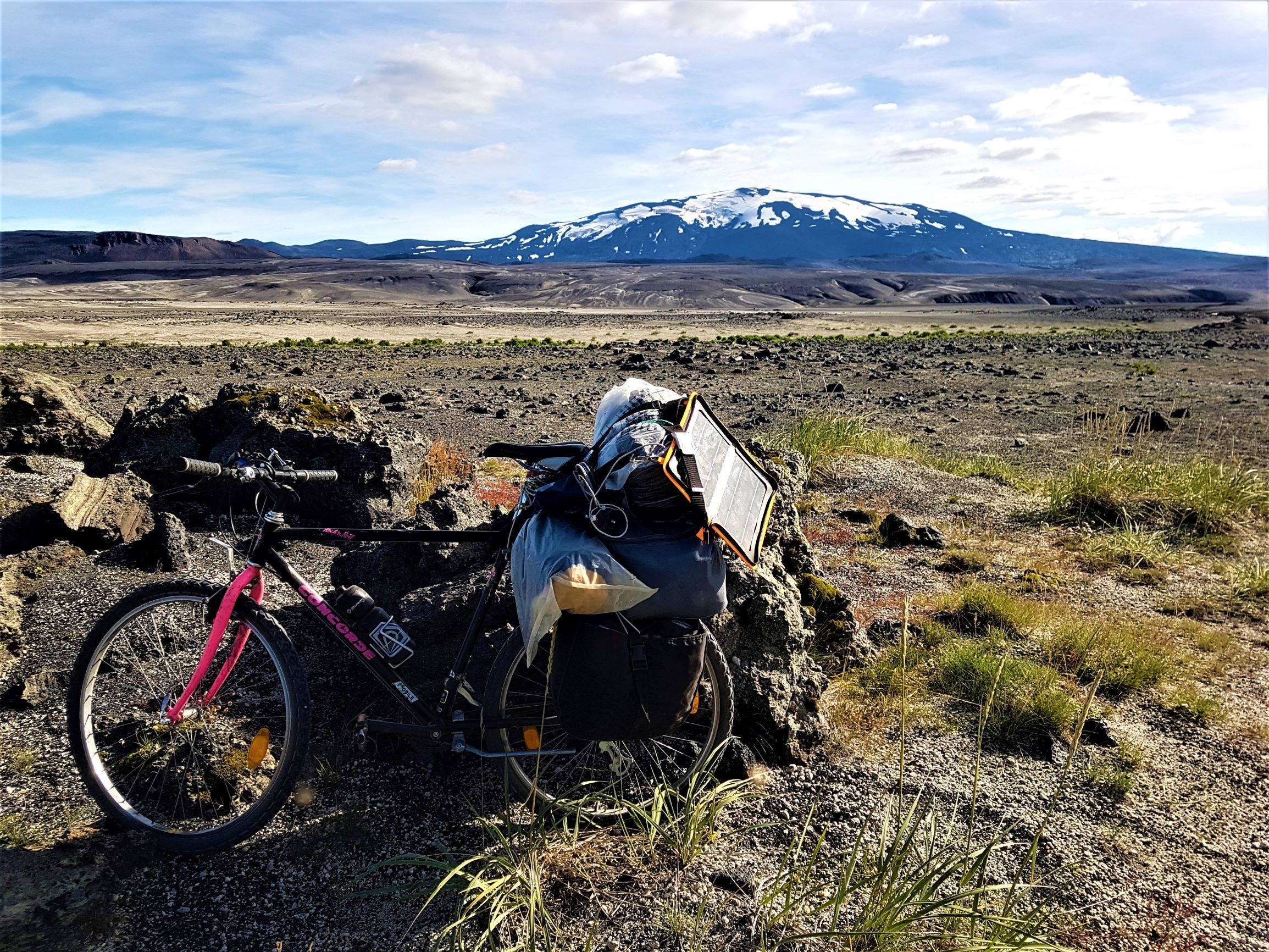 A bike packed with bags on an eco-cycling trip through Iceland's unusual volcanic terrain