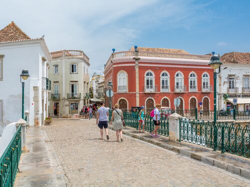 pedestrians walk in a historic district of Faro