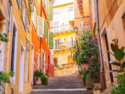 Colorful buildings line a set of stairs in Nice, France 
