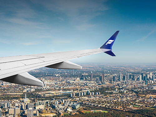 An aircraft with Icelandair livery design pictured flying overhead a scene of Frankfurt city 