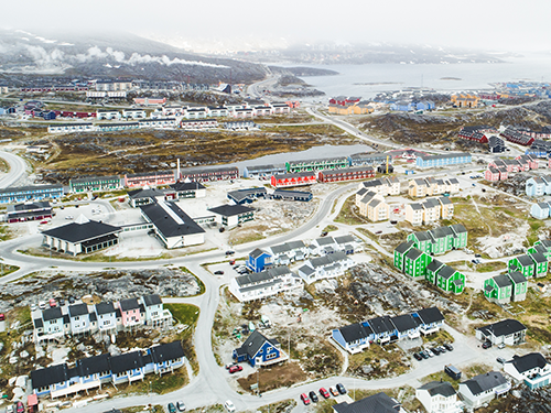 An overhead shot of Nuuk, Greenland with the colorful pictures in shot 