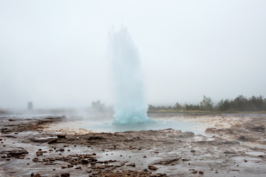 Strokkur geyser, a location which inspired Disney'S Frozen locations, shown here on a misty day