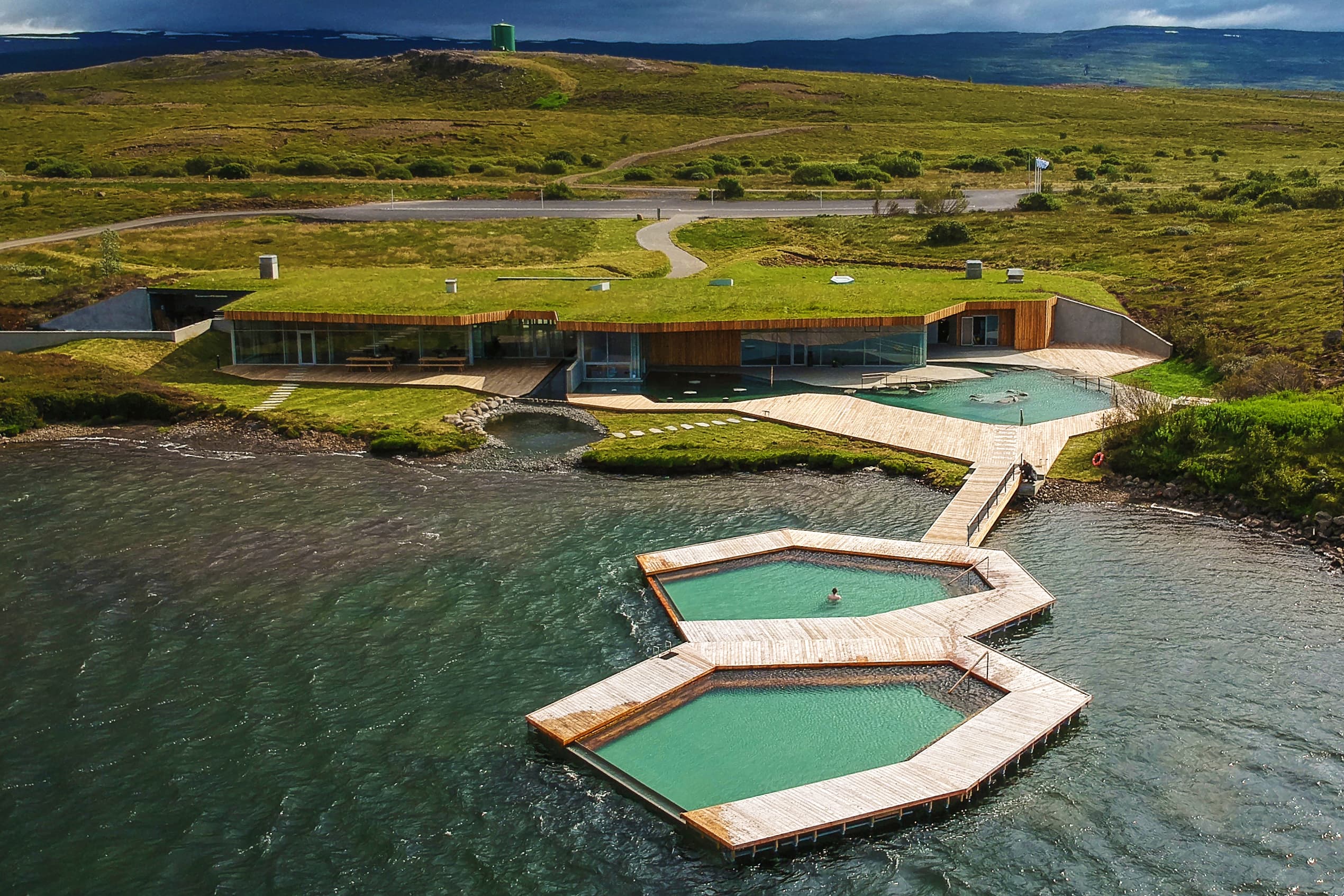 Vok baths in Iceland viewed from overhead - two hexagon shaped pools positioned next to another square pool and small bath