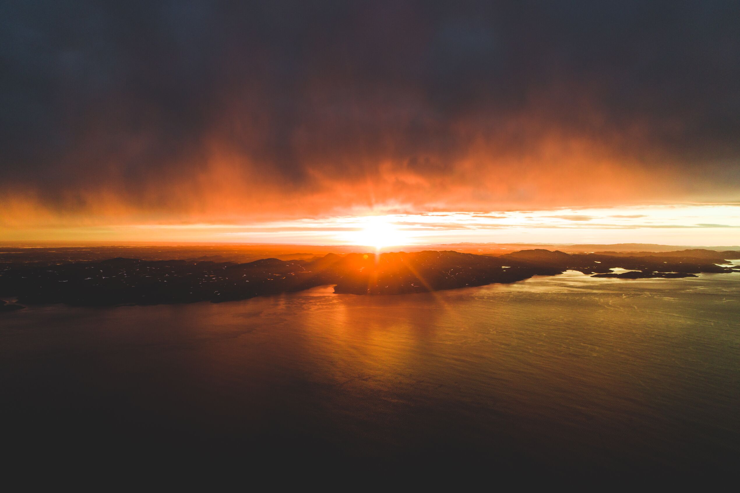 An aerial view of the shore of Greenland at sunset