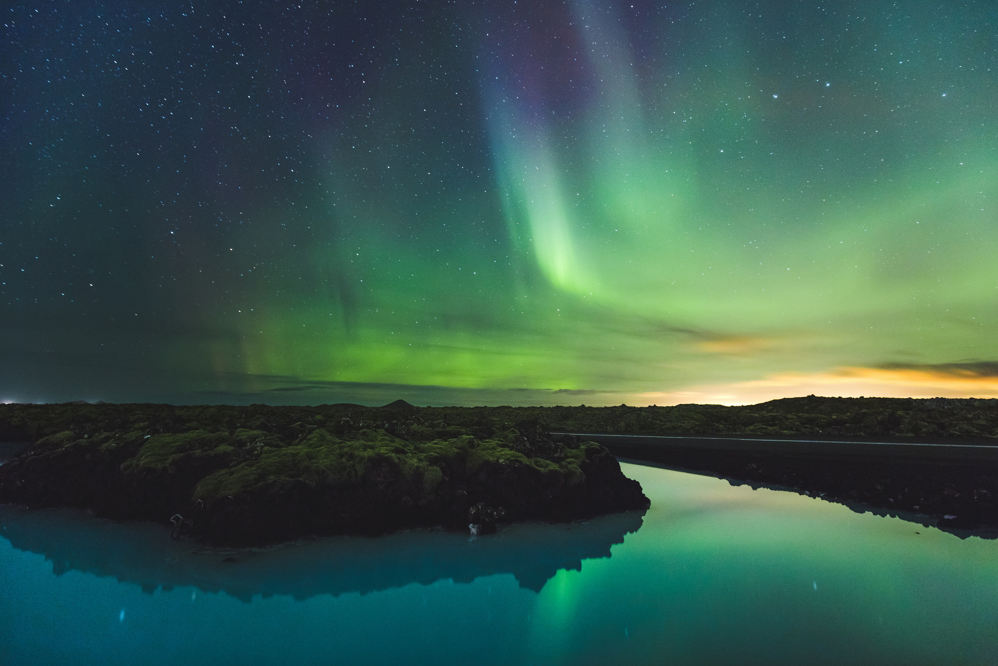 Northern lights aurora shine over the Blue Lagoon