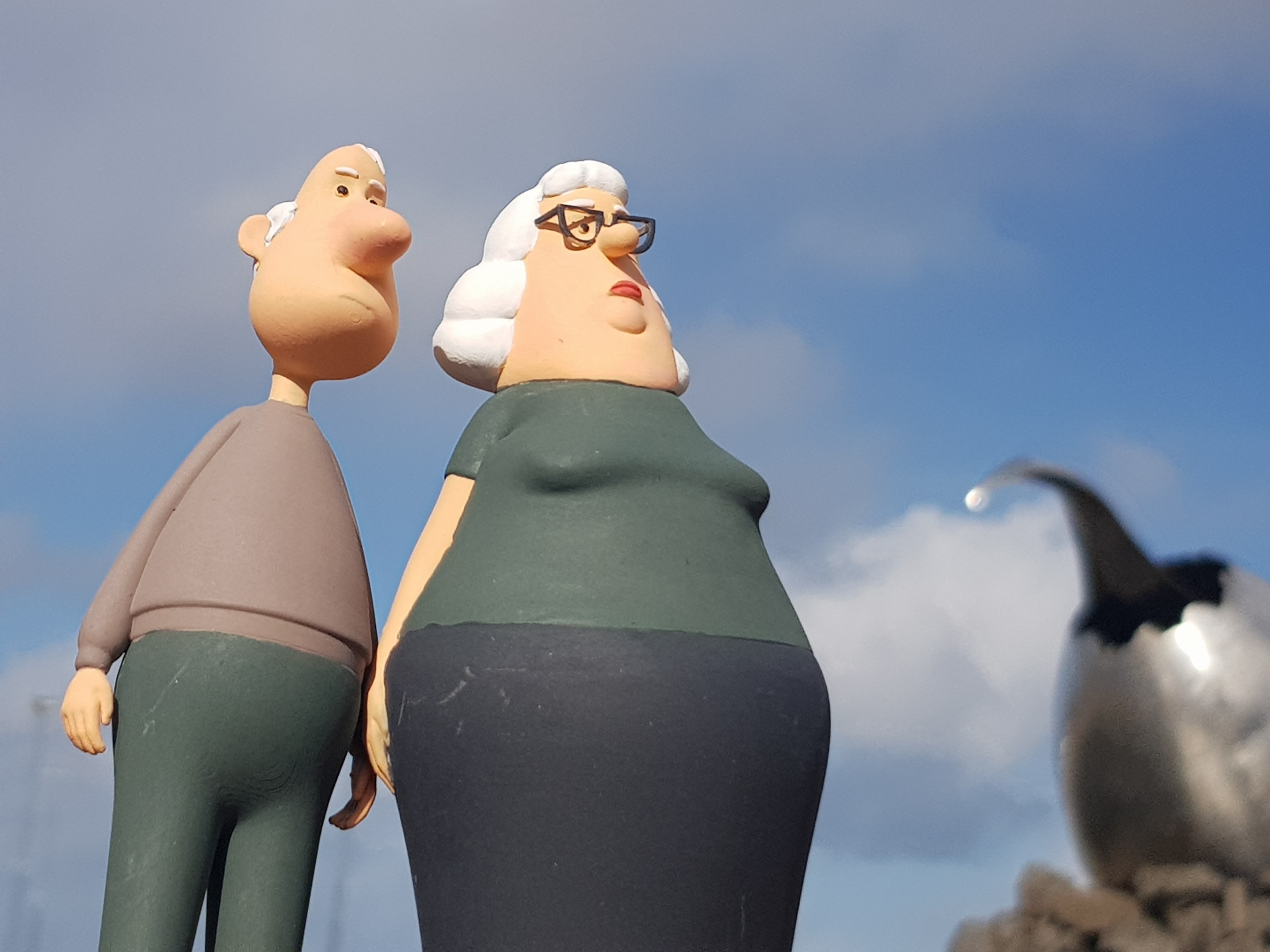 The Yes People, from the Icelandic short film of the same name, pictured from below with a blue sky above
