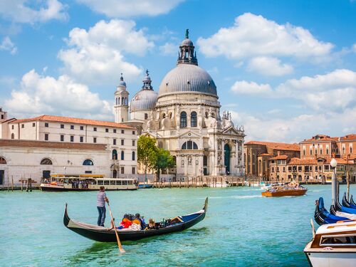 a classic gondola navigates the grand canal in Venice