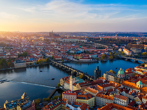 An overhead shot of the city of Prague, with the Charles Bridge in center of the shot and the city stretched out on both sides