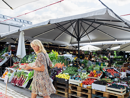 A woman browses a fruit and veg market in Copenhagen