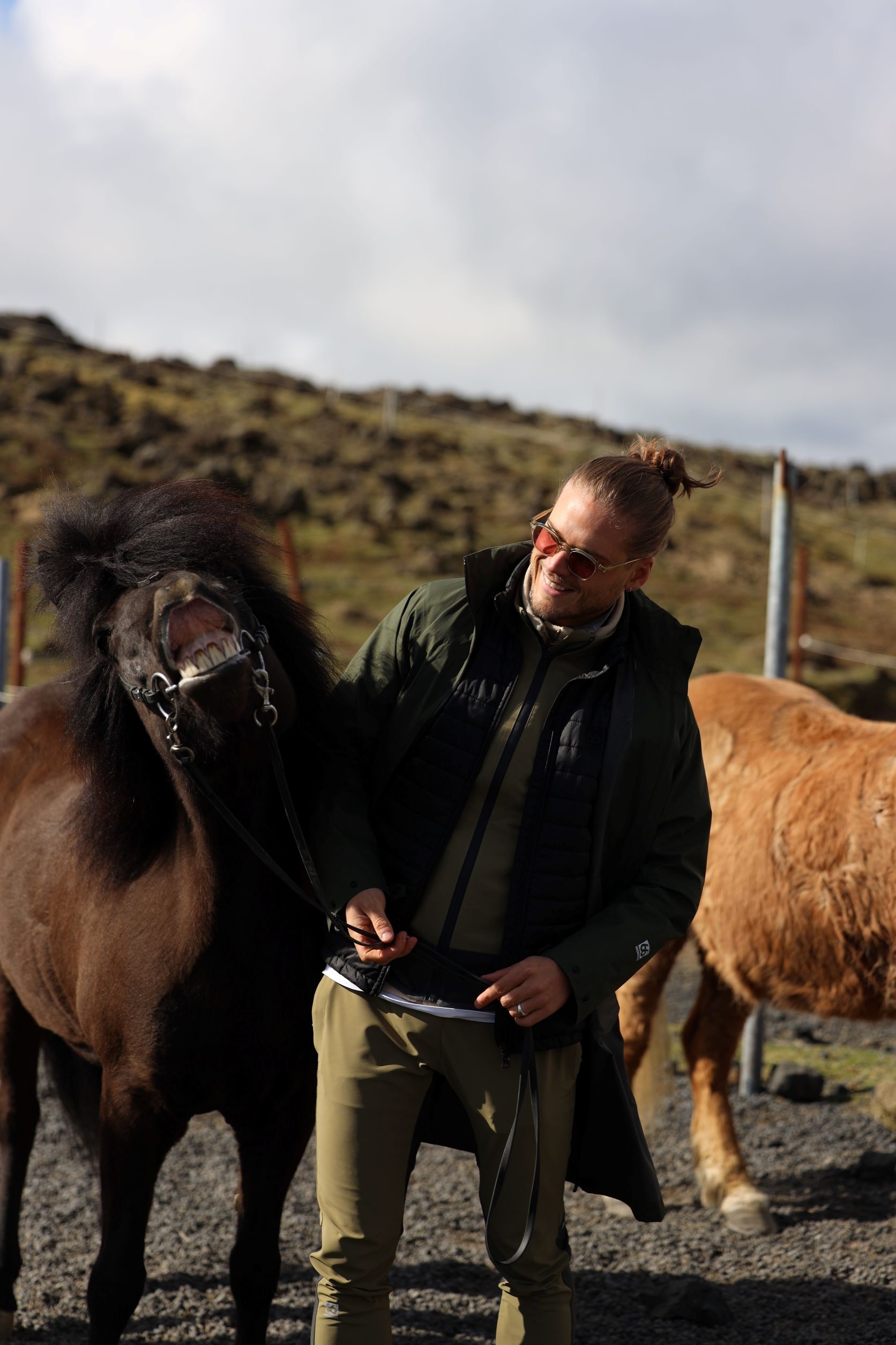 Rurik Gislason stands next to a black horse