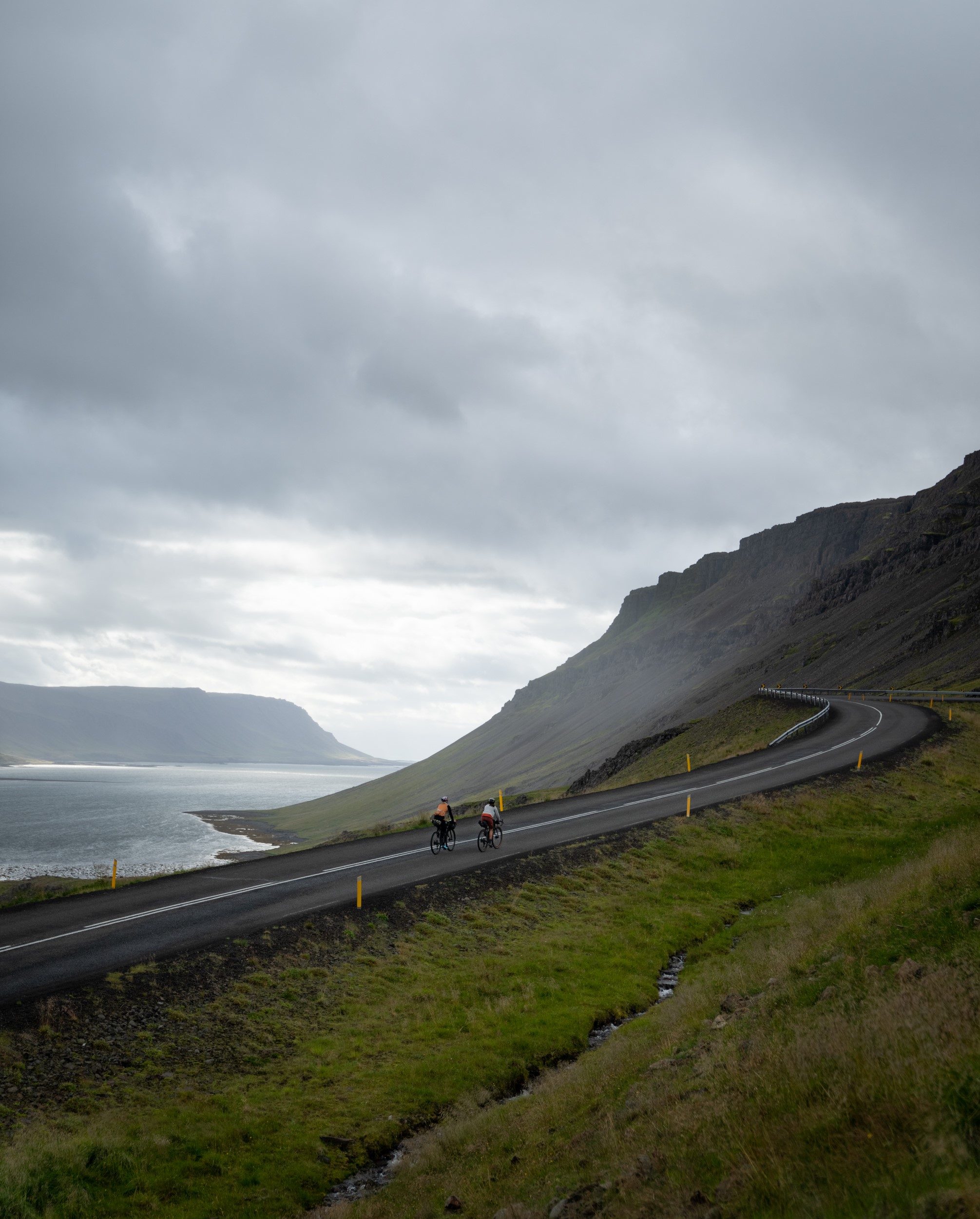 Cyclists on a mountain road in the Westfjords