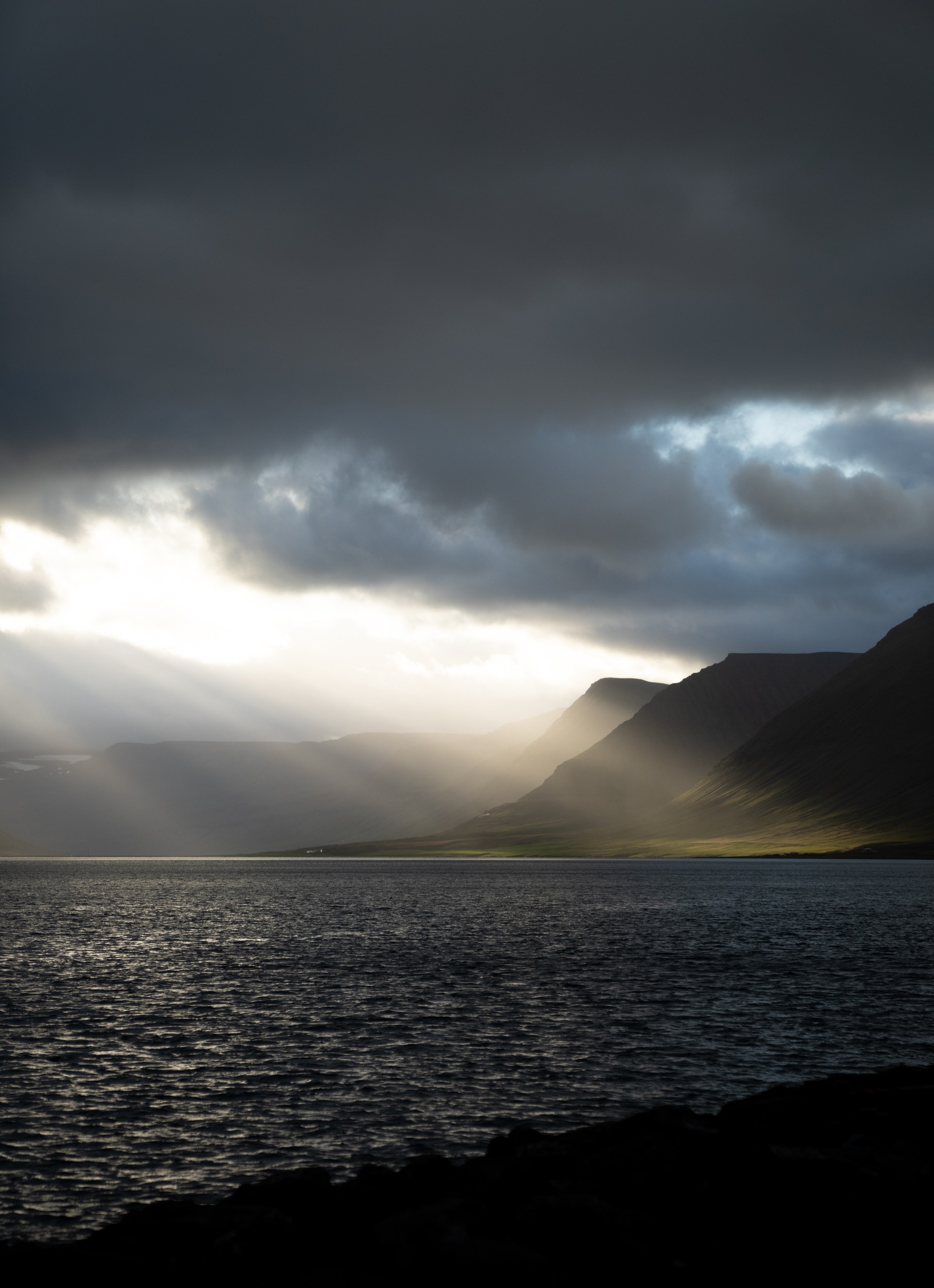 Sunlight hitting mountain landscape of the Westfjords