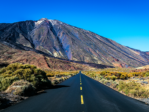 A road running alongside the volcanic Mount Teide in the Northern region of the island of Tenerife