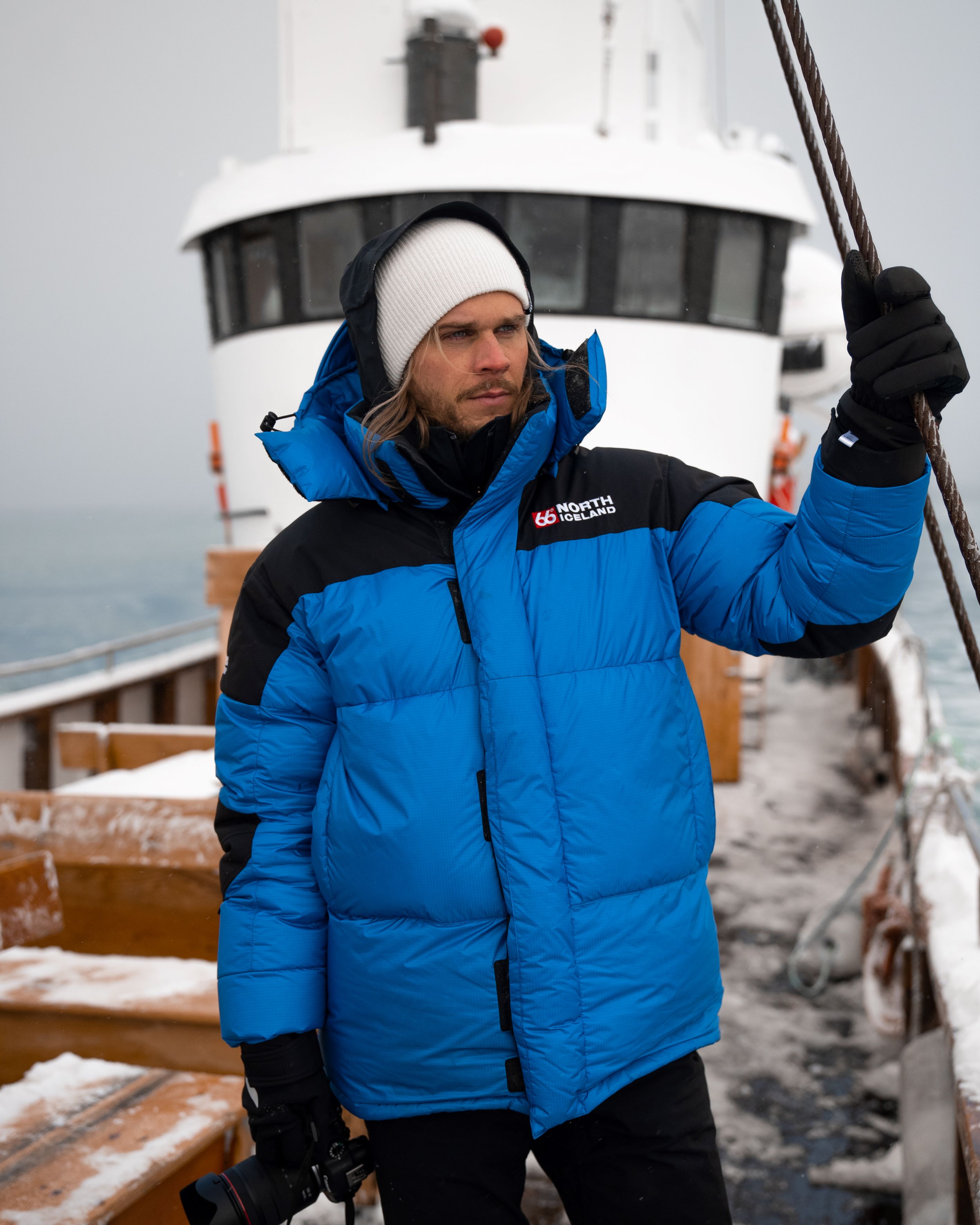 Rúrik Gíslason stands on an old wooden boat now used for whale-watching trips from the town of Húsavík in North Iceland.