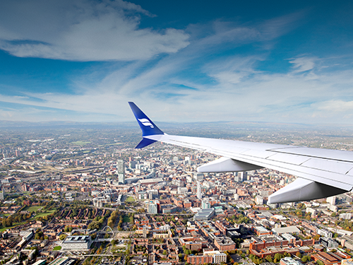 An Icelandair plane flies over the city of Manchester in the United Kingdom 