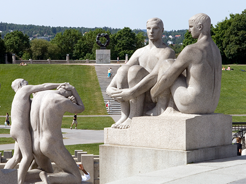 Pale white sculptures of people sitting and fighting, hosted within Vigeland Park, Oslo 