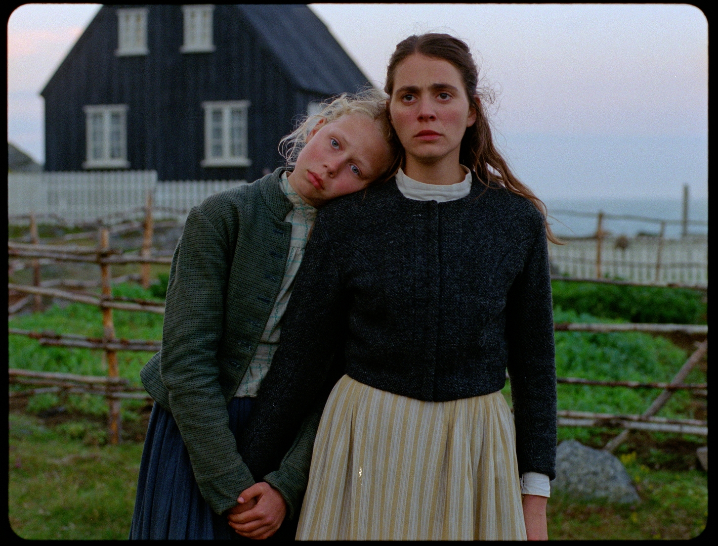 Production photo from the set of Godland the movie, showing two sisters on a farm