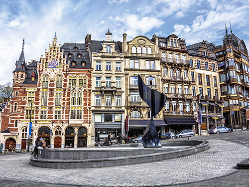 People milling around the metal structure on Coudenberg Street in Brussels, Belgium 