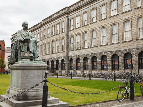 The courtyard of Trinity College in Dublin. A statue in the foreground of the nineteenth-century historian William Lecky