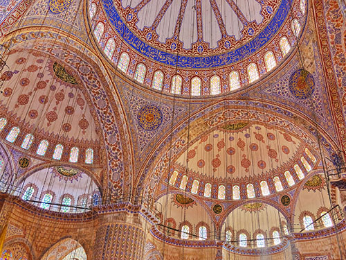 Magnificently decorated ceilings inside the Blue mosque in Istanbul