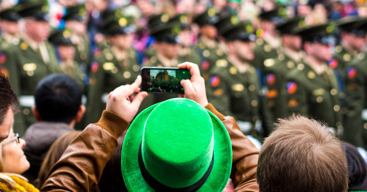 St Patrick's Day celebrations in Boston viewed from the perspective of a person wearing a green top hat and filming the green guard