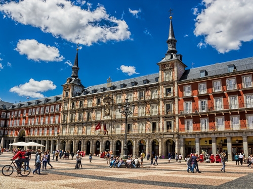 Plaza Mayor in Madrid, Spain, as pictured from ground level with people milling around