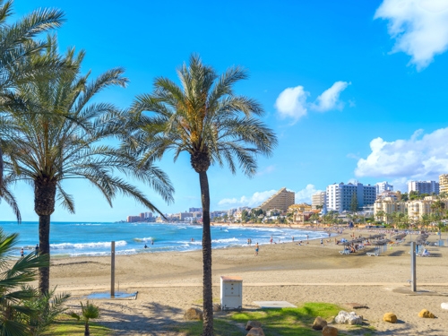 a beach with a view of Malaga