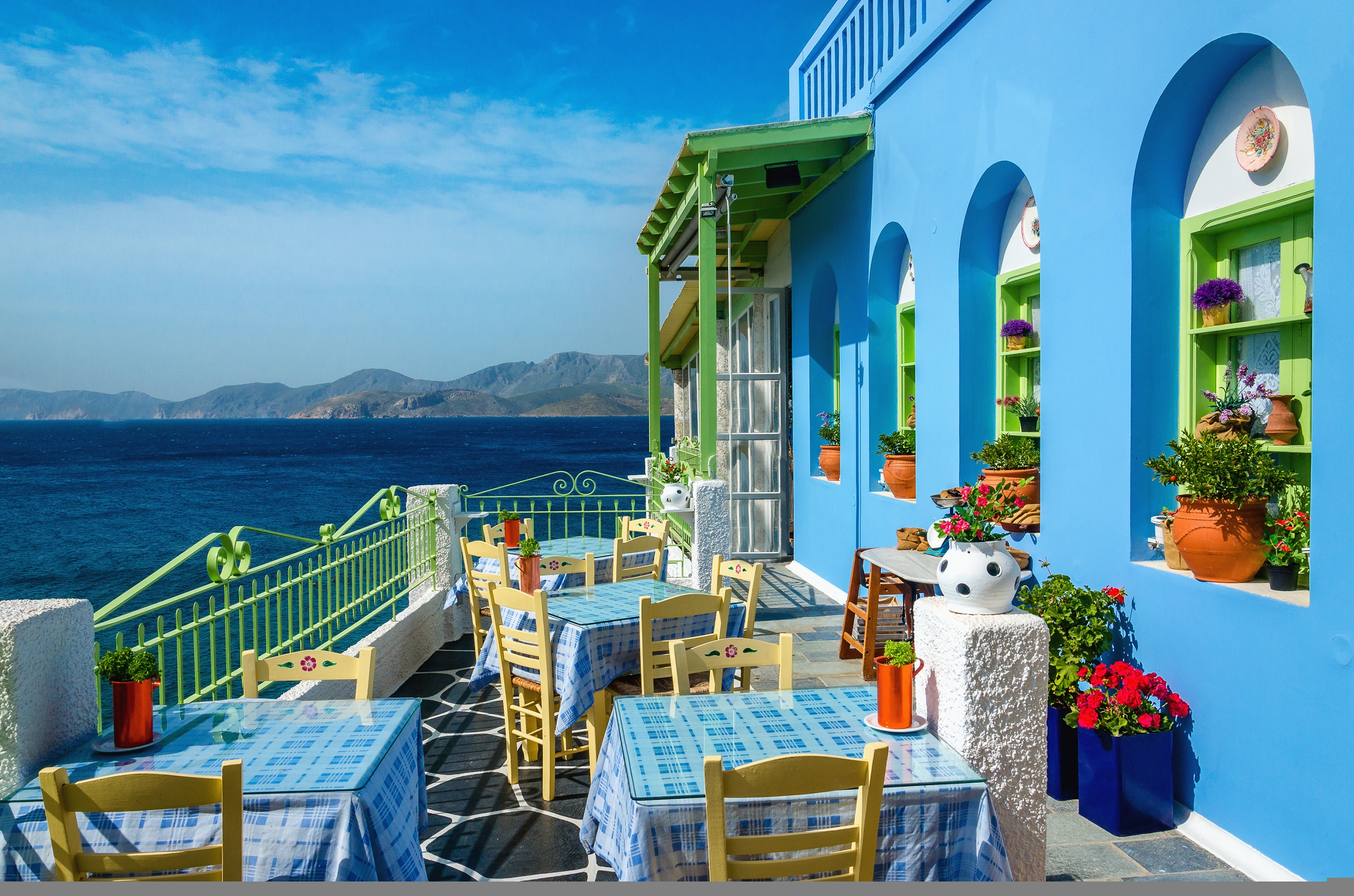 A scene of a colourful restaurant with an ocean view in Crete, Greece 