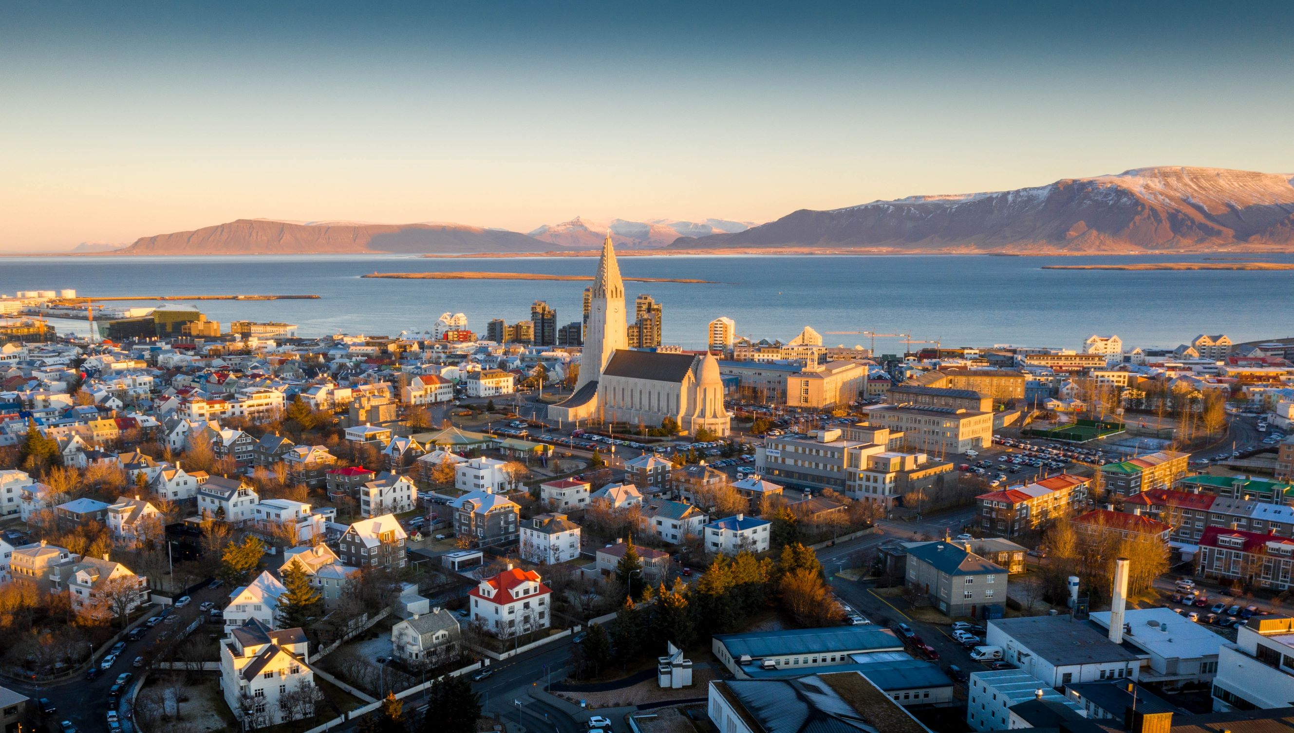 an aerial view of Reykjavik, with Hallgrimskirkja pictured during a bright blue sky day